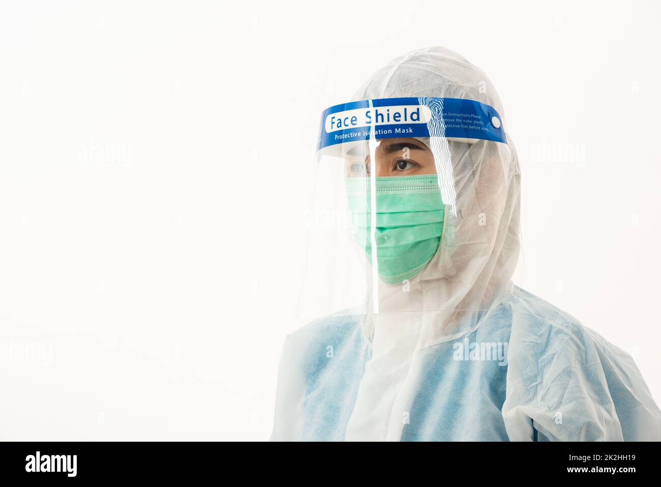 woman medical staff doctor in PPE uniform wearing a face mask protective and plastic face shield Stock Photo