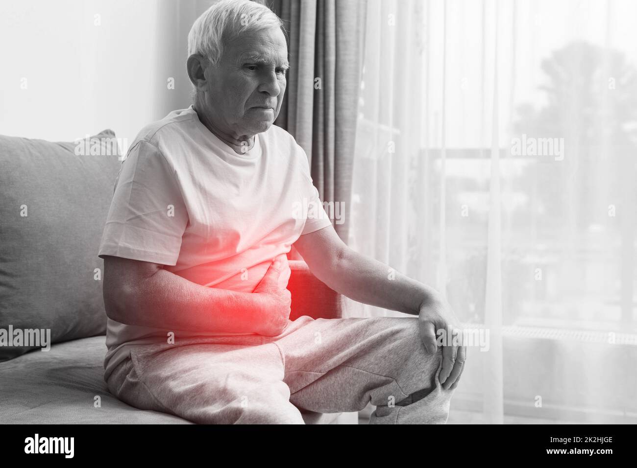 Senior man is suffering from problems with a digestion Stock Photo