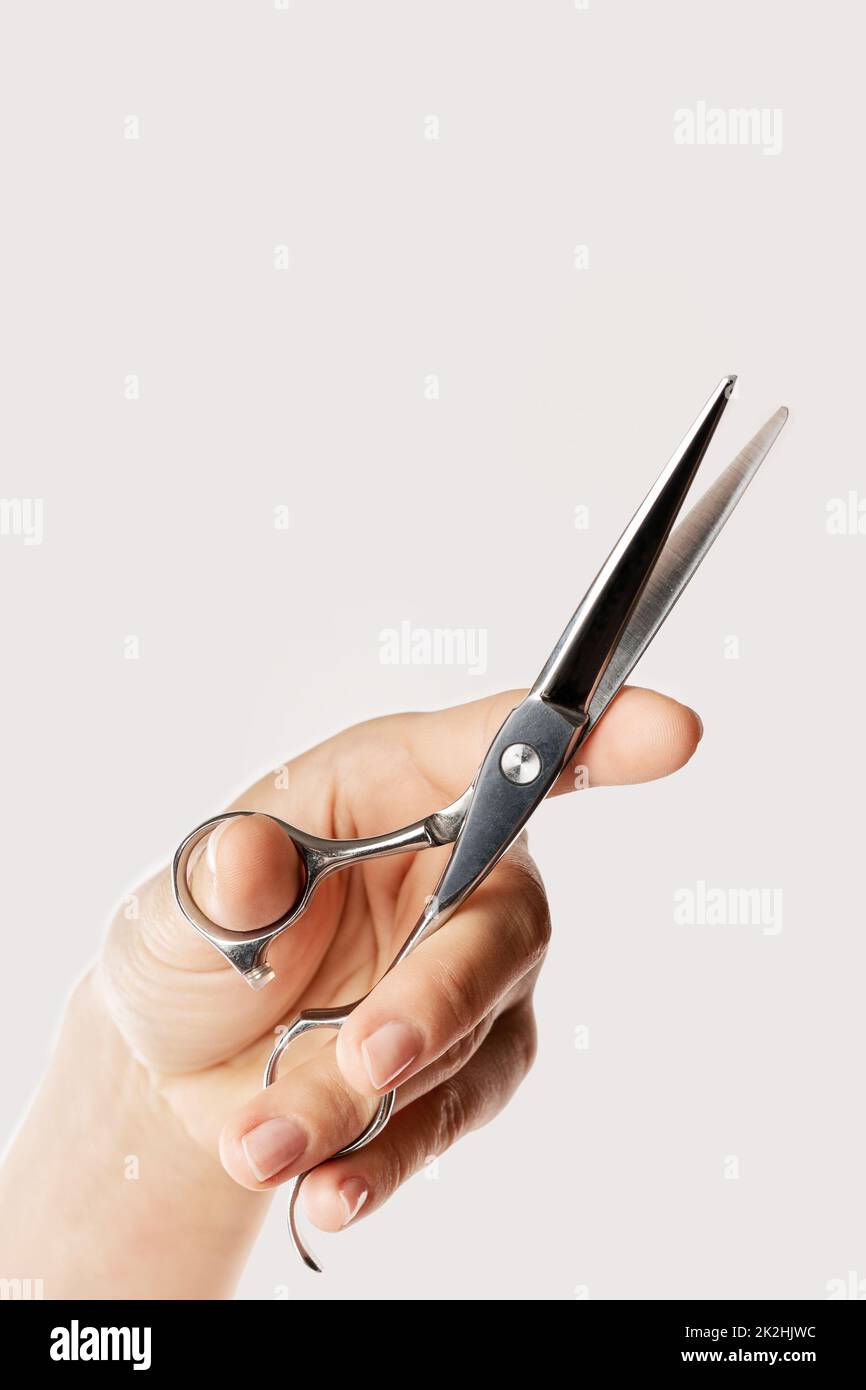 Female hand with a hair cutting shears Stock Photo