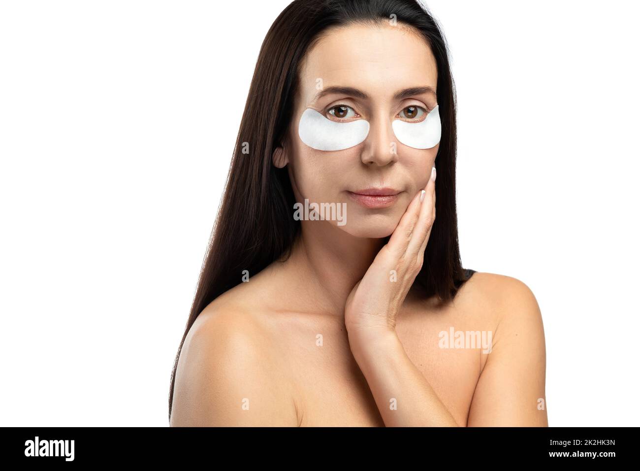 Middle aged woman with applied sheet patches under her eyes. Stock Photo