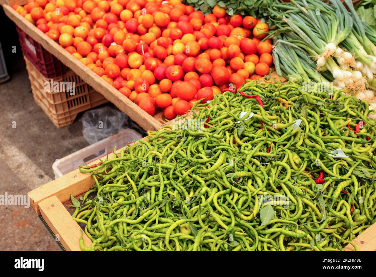 Thin green peppers tomatoes and onions displayed on food market, Kyrenia, Nortern Cyprus Stock Photo