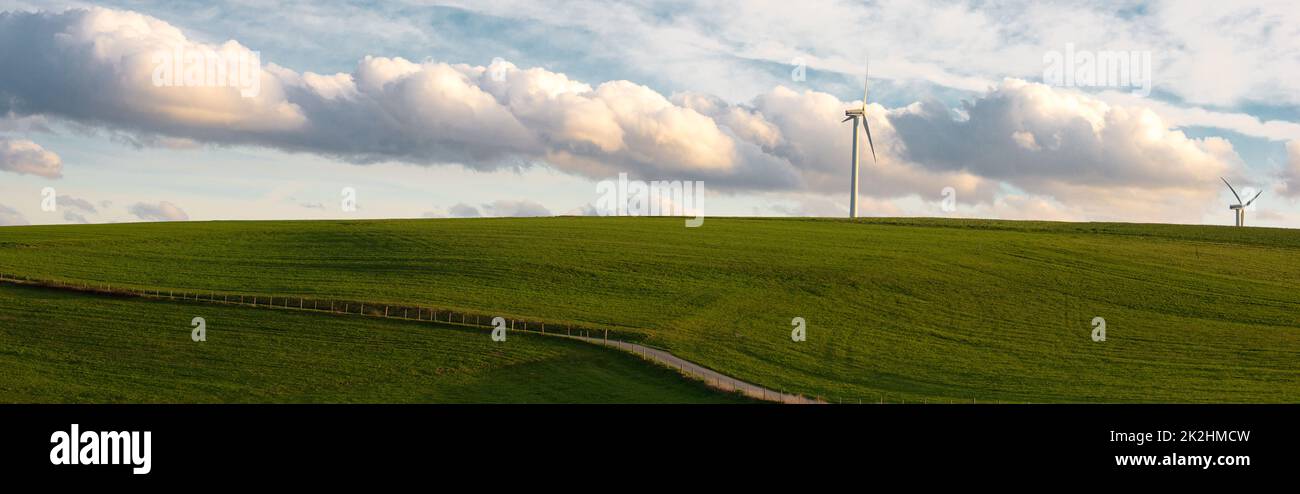 Stormy weather in the spring, clouds in the sky, green meadow, agriculture in Germany, landscape, wind energy and environment discussion, countryside scene Stock Photo