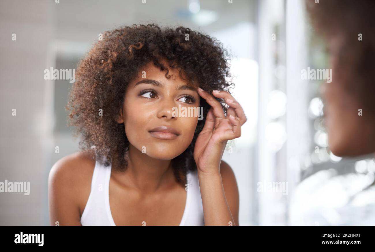 Perfectly shaped. Shot of an attractive young woman looking at herself