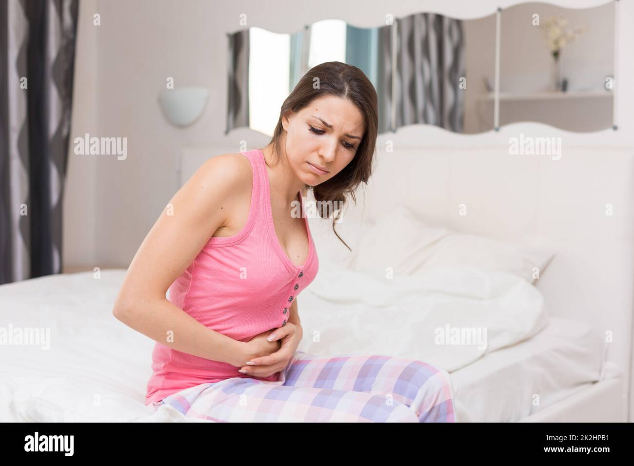 Unhealthy Woman Sitting On Bed Touching Her Stomach Suffering From More ...