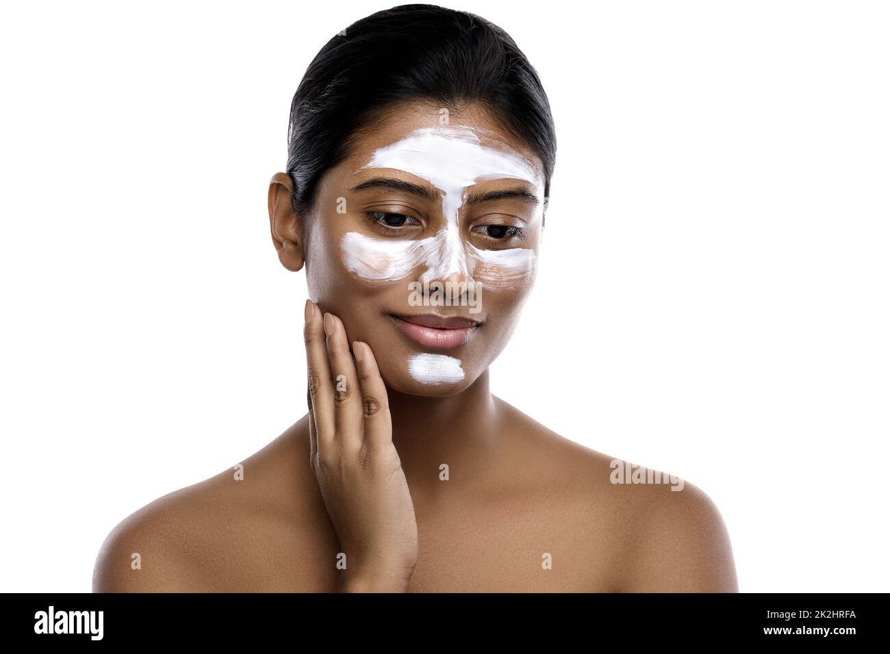 Young indian woman with a cleansing mask applied on her face Stock