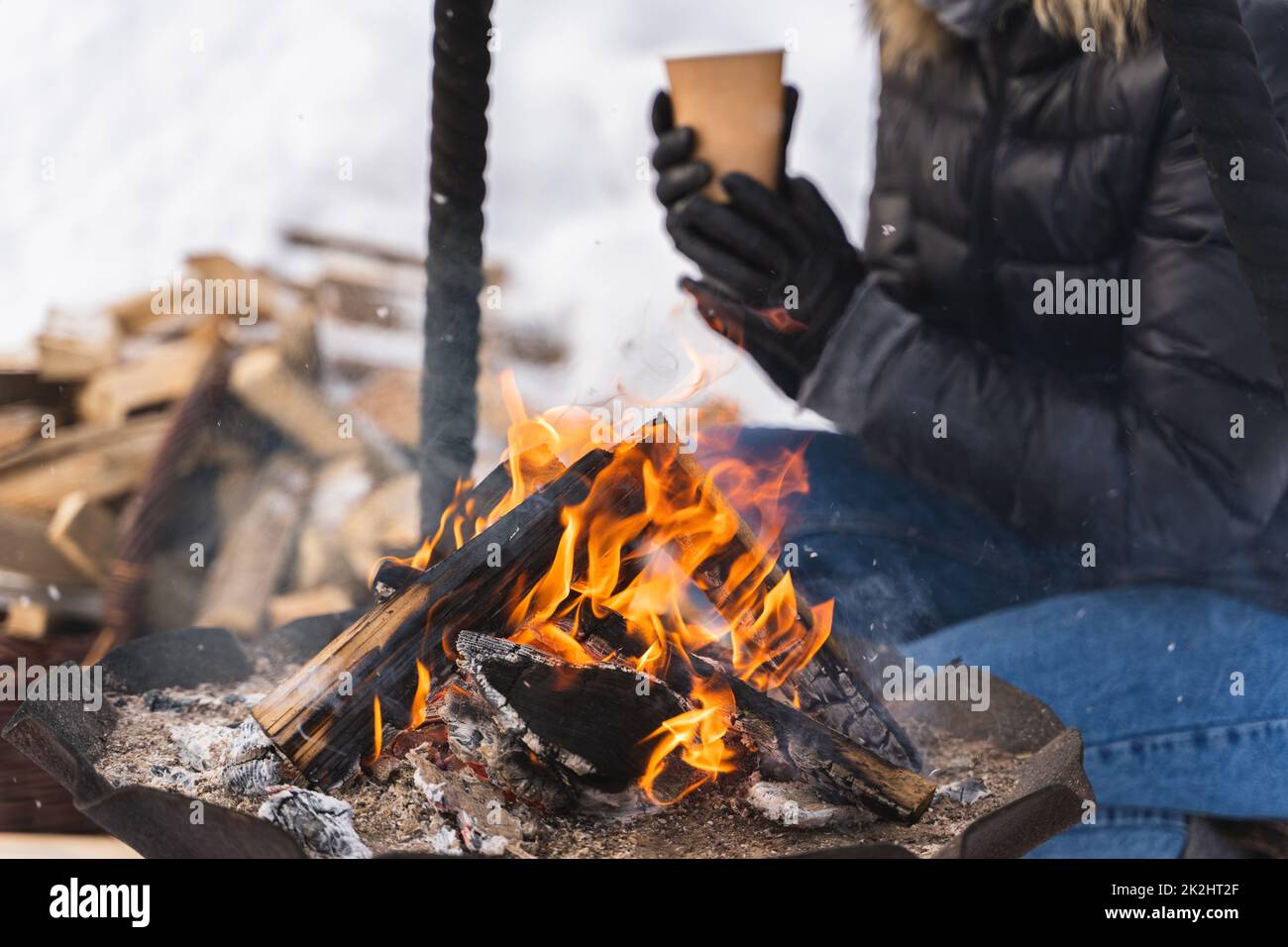 Firewood burning inside the firepit during cold winter day Stock Photo