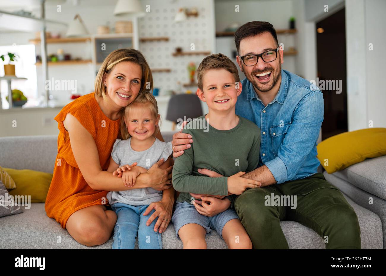 Happy family having fun time at home. Parents playing smiling with childrens together. Stock Photo