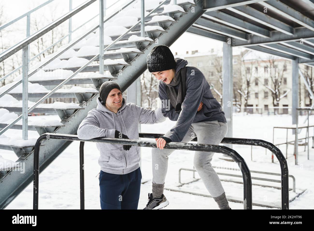 Young sportive couple during calisthenics workout during winter Stock Photo