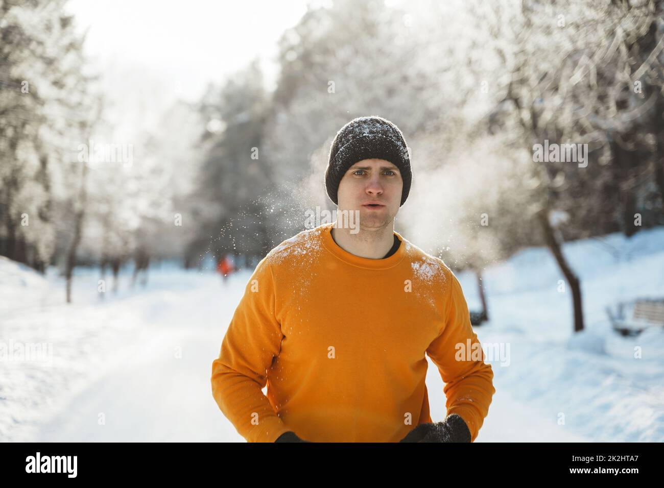 Young jogger man during his workout in winter park Stock Photo