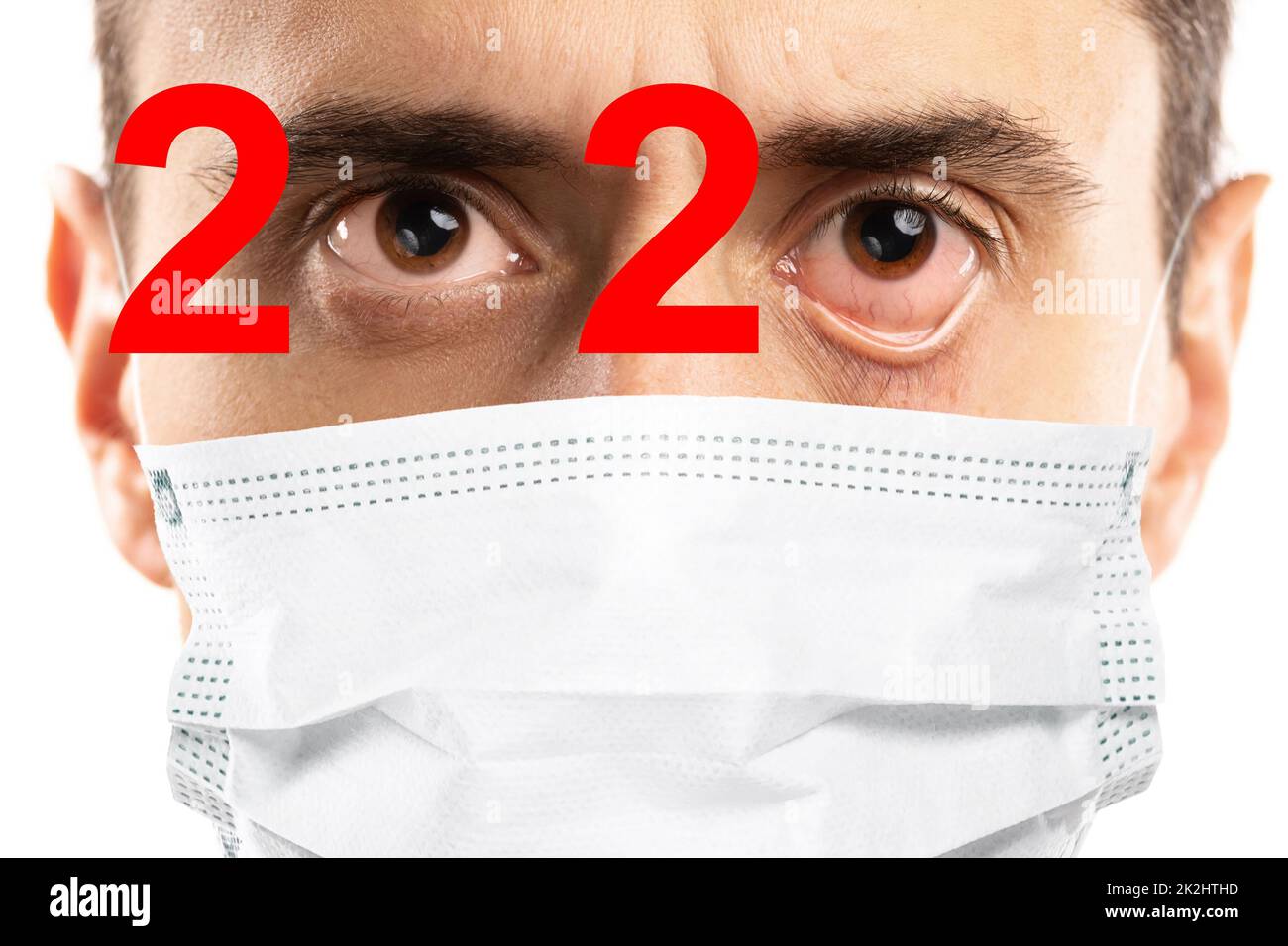2020 was a COVID-19 pandemic year. Man with symptoms wearing mask. Stock Photo