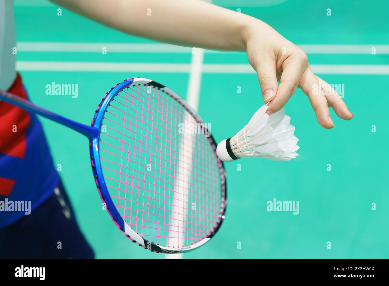 woman holding a badminton racket ready to hit shuttecock Stock Photo
