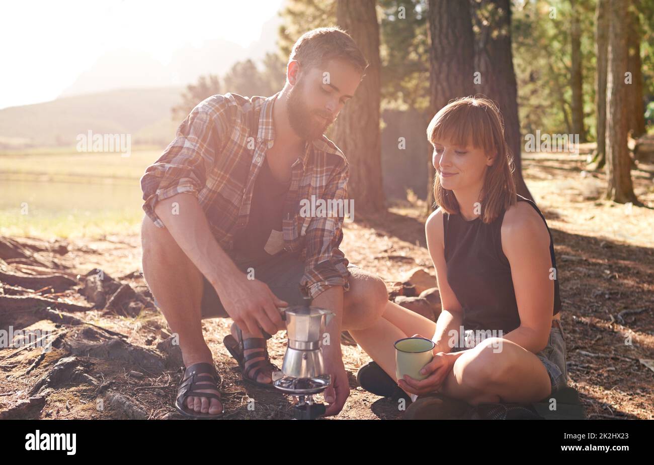 Even campers need coffee. Shot of a young couple making coffee on a