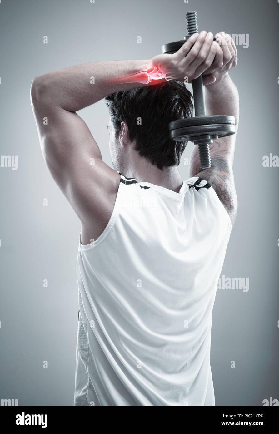 Exercising his triceps. Cropped shot highlighting a sportsperson's