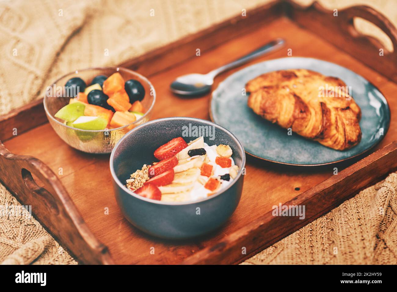 Great food is a lifestyle. Cropped shot of a neatly laid out breakfast arranged on a wooden tray and served in bed at home. Stock Photo