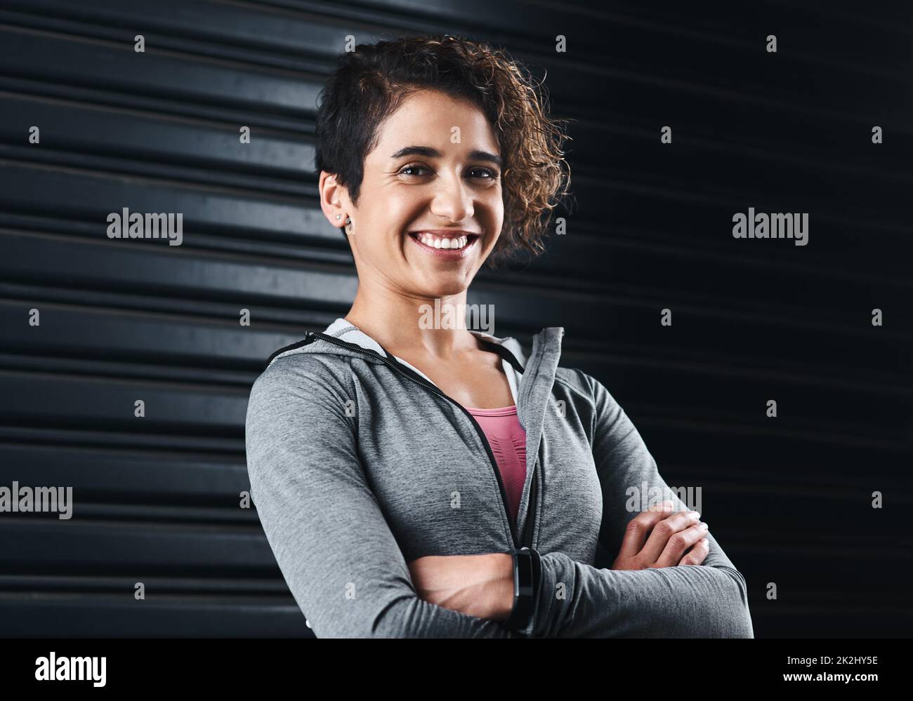 Fit is a lifestyle. Cropped portrait of an attractive young woman standing against a black background in her workout clothes before exercising. Stock Photo
