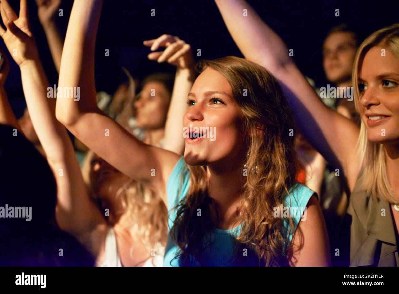 We know every lyric. Attractive female fans enjoying a concert- This concert was created for the sole purpose of this photo shoot, featuring 300 models and 3 live bands. All people in this shoot are model released. Stock Photo