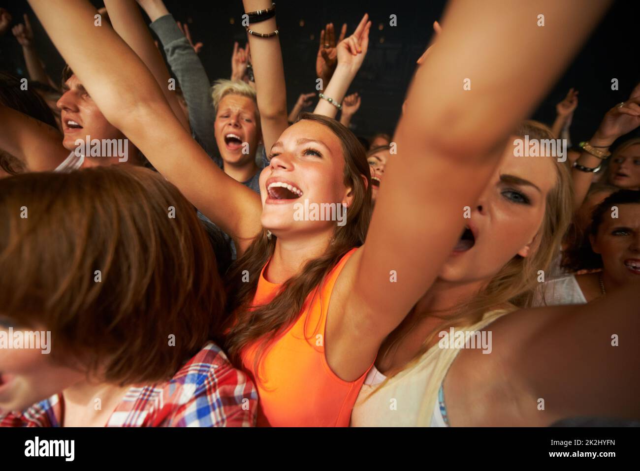 These girls love their music. Attractive female fans enjoying a concert. Stock Photo