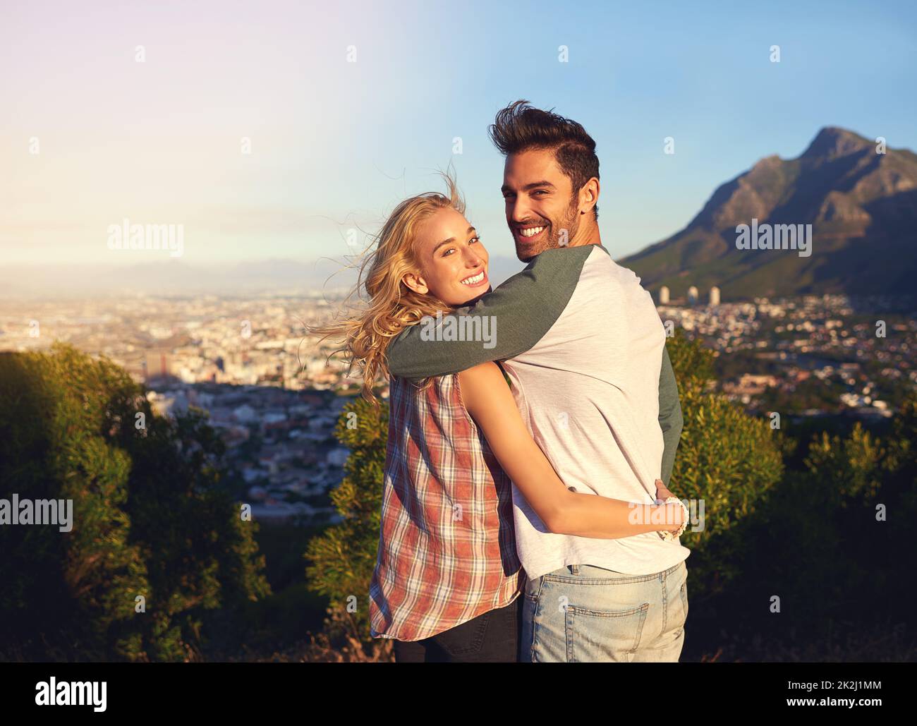 It's so beautiful out here. Portrait of an affectionate young couple admiring the view outdoors. Stock Photo