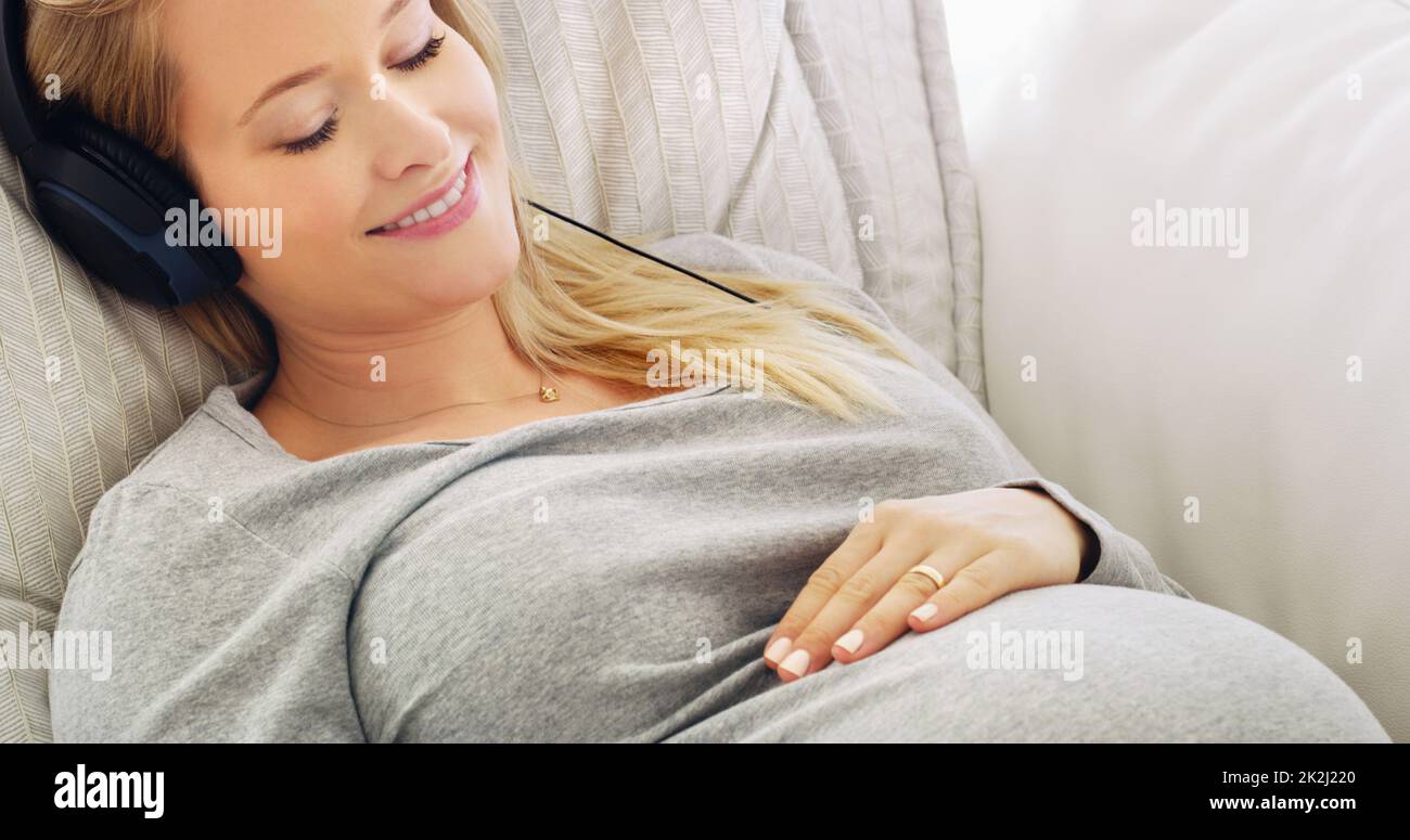Pregnant asian woman holding headphone on belly playing music to her baby  in stomach relaxing pregnancy Mental health concept 33241683 Stock Photo at  Vecteezy