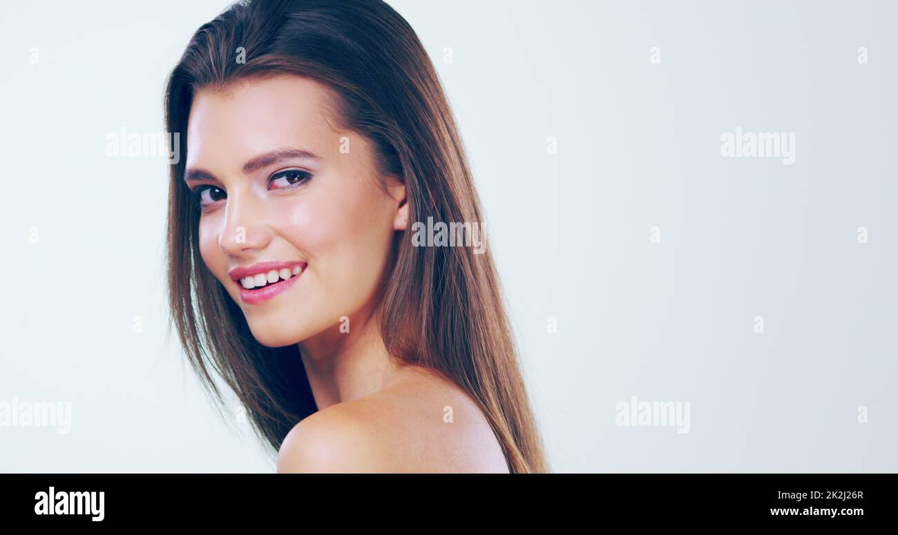 Feminine and beautiful. 4k video footage of a beautiful young woman with gorgeous hair posing in the studio. Stock Photo