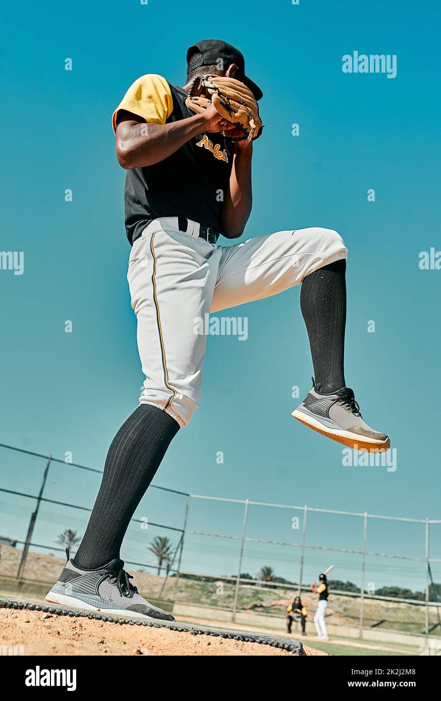 Hes giving it all hes got. Shot of a young baseball player getting ready to pitch the ball during a game outdoors. Stock Photo