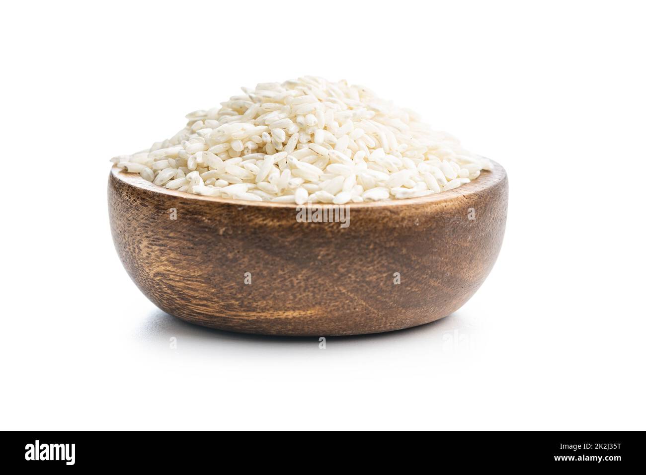 Uncooked Carnaroli risotto rice in bowl isolated on white background. Stock Photo