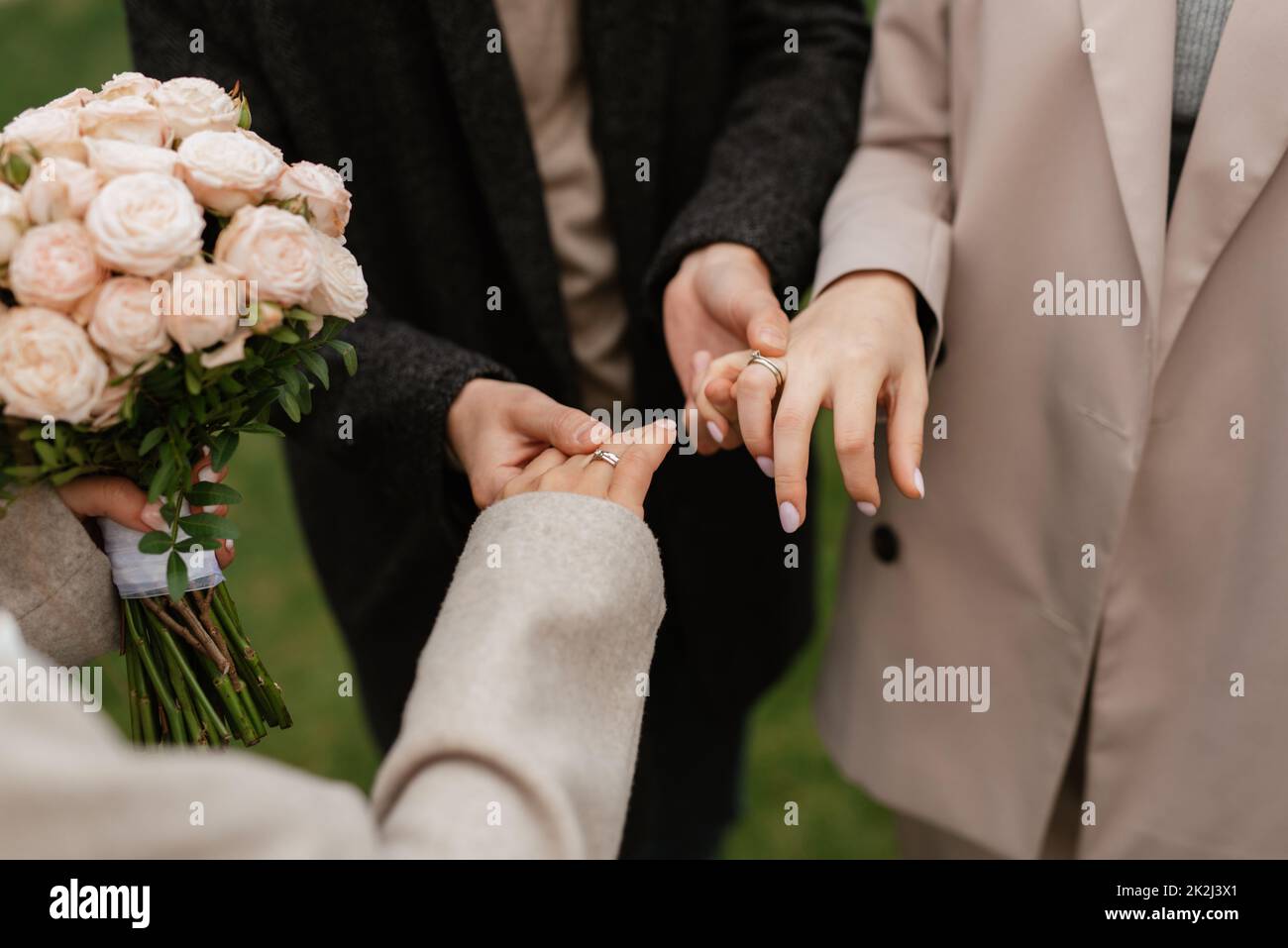 the bride and groom tenderly hold hands Stock Photo