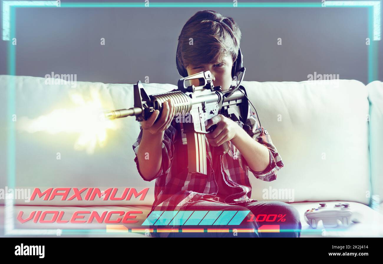 Youre under attack.. Shot of a young boy playing violent video games. Stock Photo
