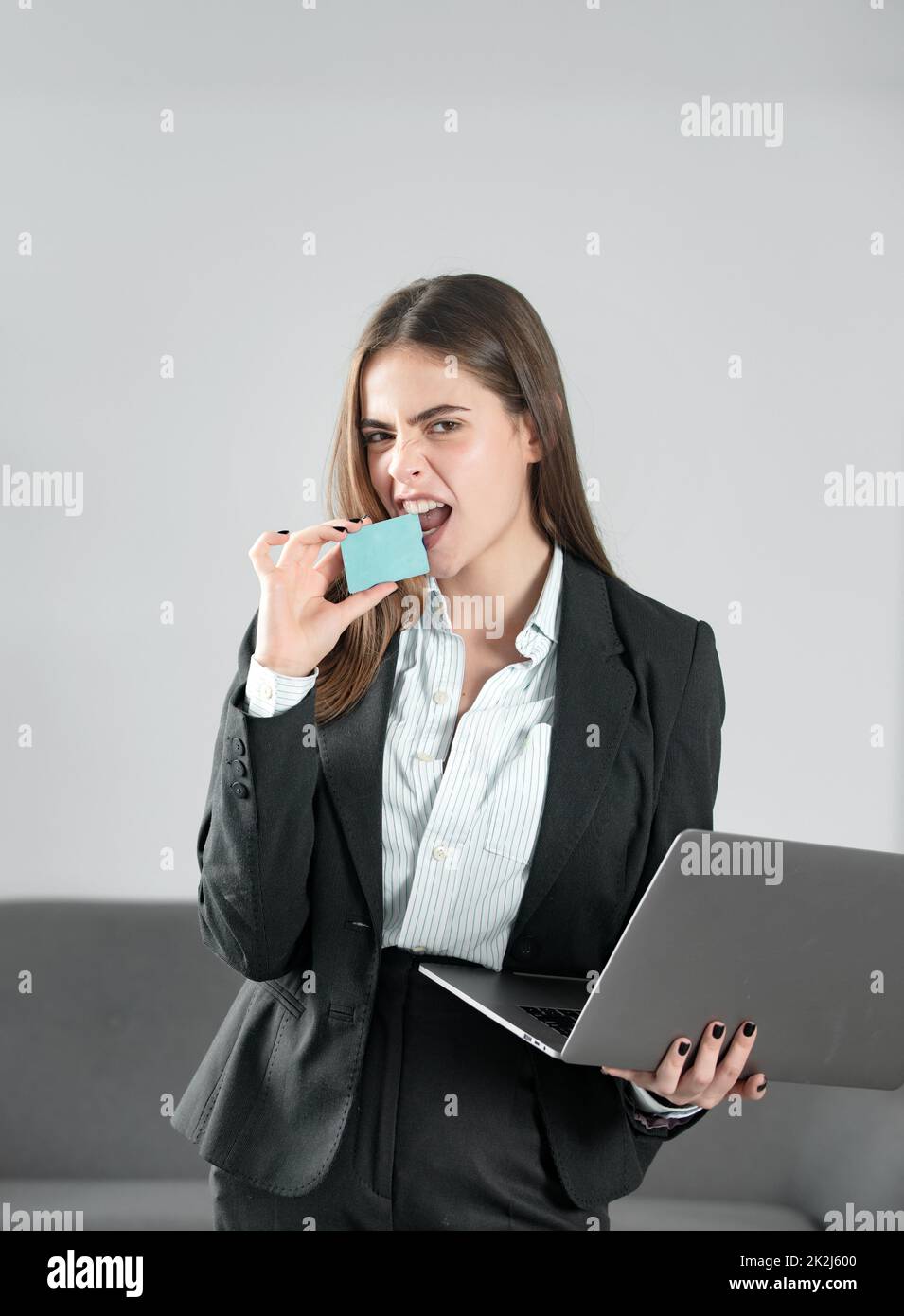 Portrait of young funny businesswoman accountant in formal wear at office. Young crazy secretary with laptop credit card in office. Financial services Stock Photo