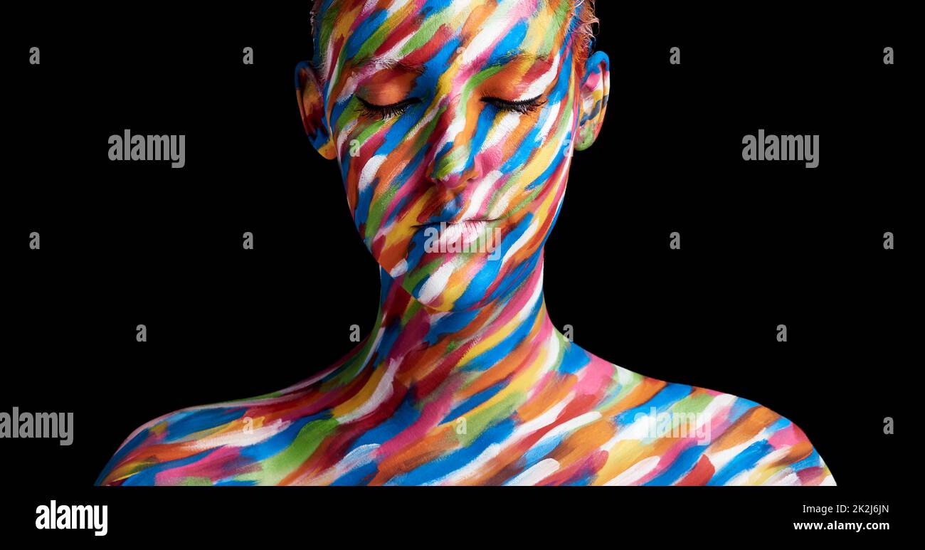 In living colour. Cropped shot of a young woman posing with paint on her face. Stock Photo