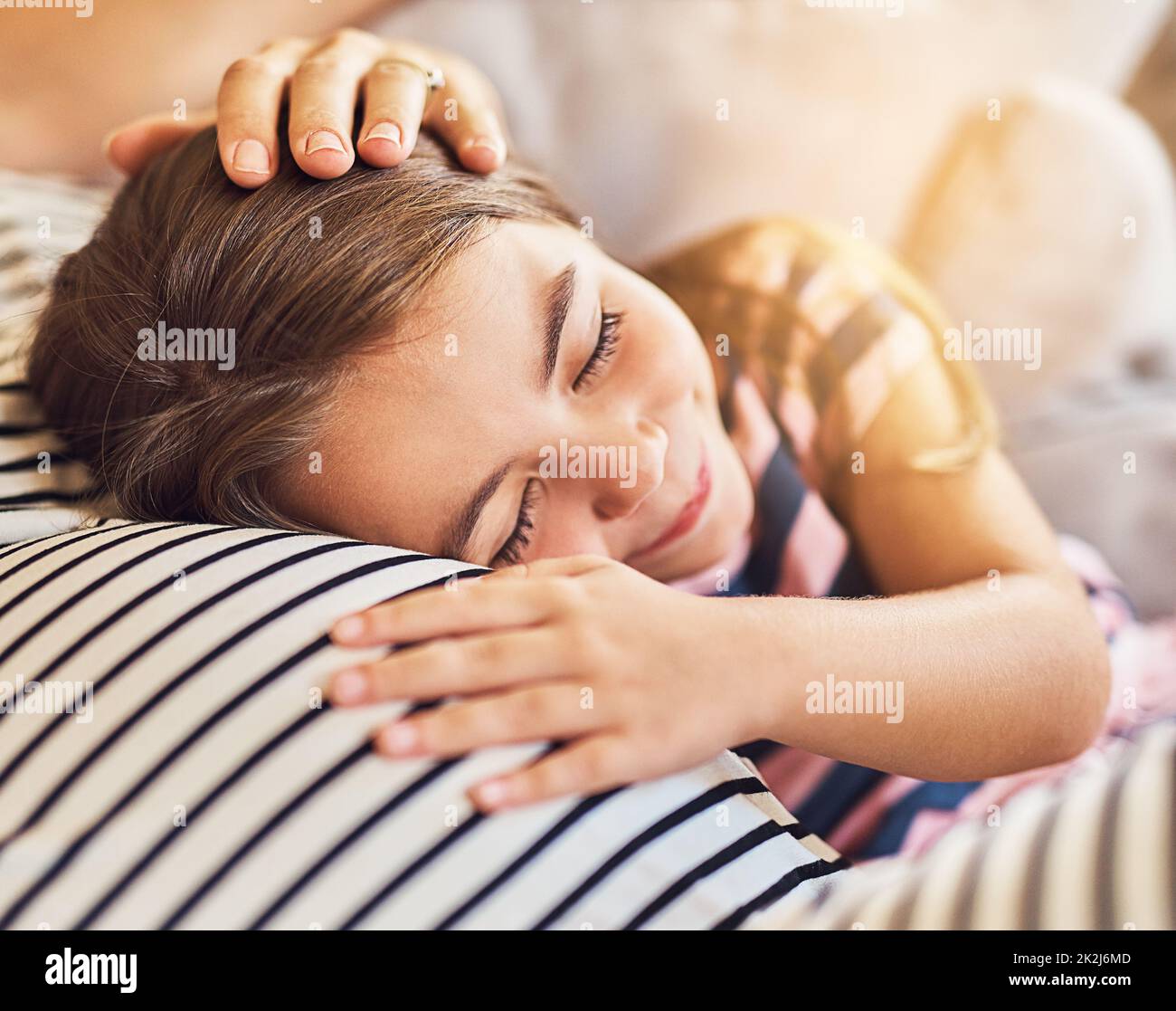 I love you already. High angle shot of an adorable little girl cuddling her pregnant mothers stomach. Stock Photo