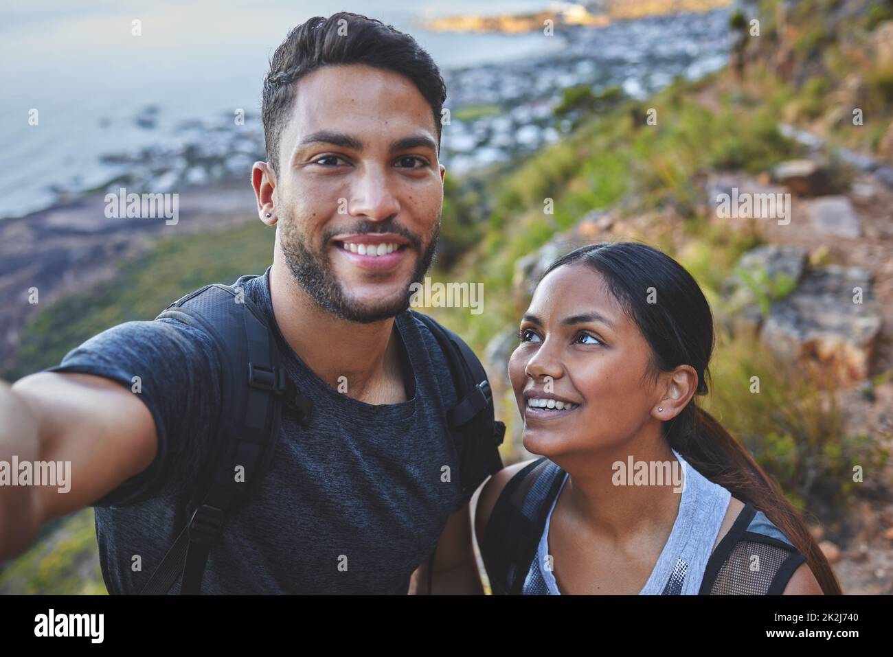 Well always have our hikes. Shot of a young couple taking photos while out on a hike in a mountain range outside. Stock Photo