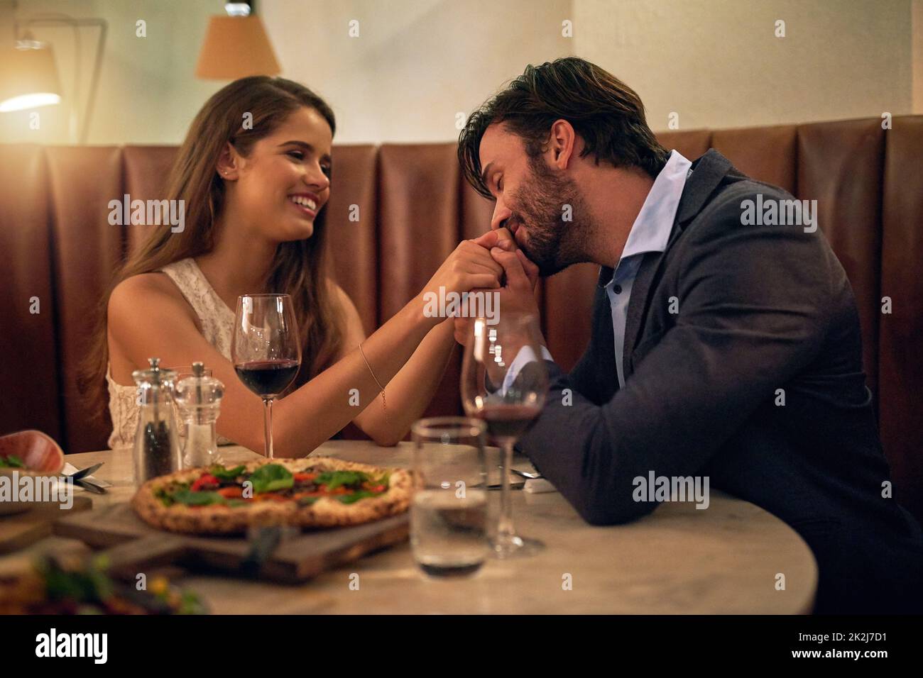 Romance level Expert. Shot of an affectionate young couple enjoying a romantic dinner date at a restaurant. Stock Photo