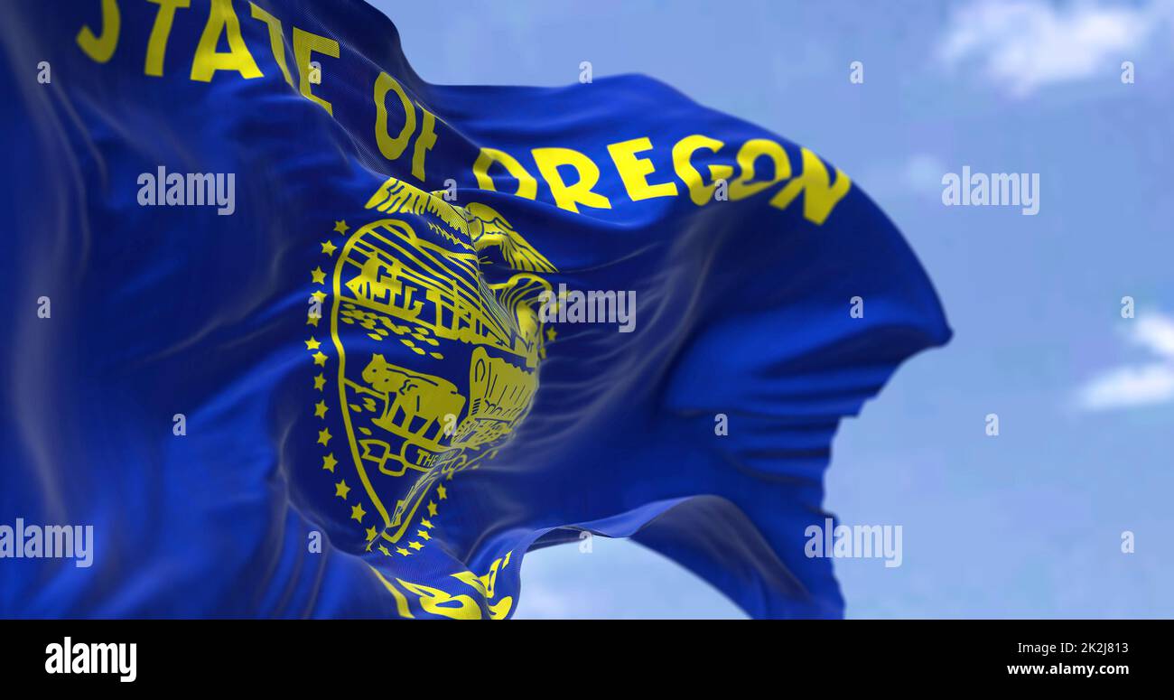 The US state flag of Oregon waving in the wind Stock Photo