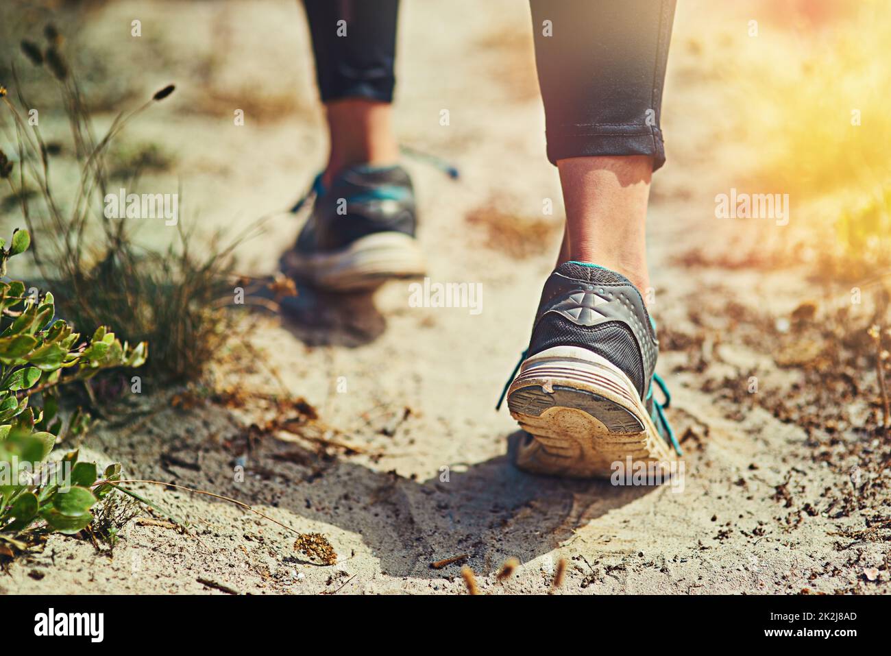 To begin the run is what matters. Close up shot of an unrecognizable womans sneakers outdoors. Stock Photo