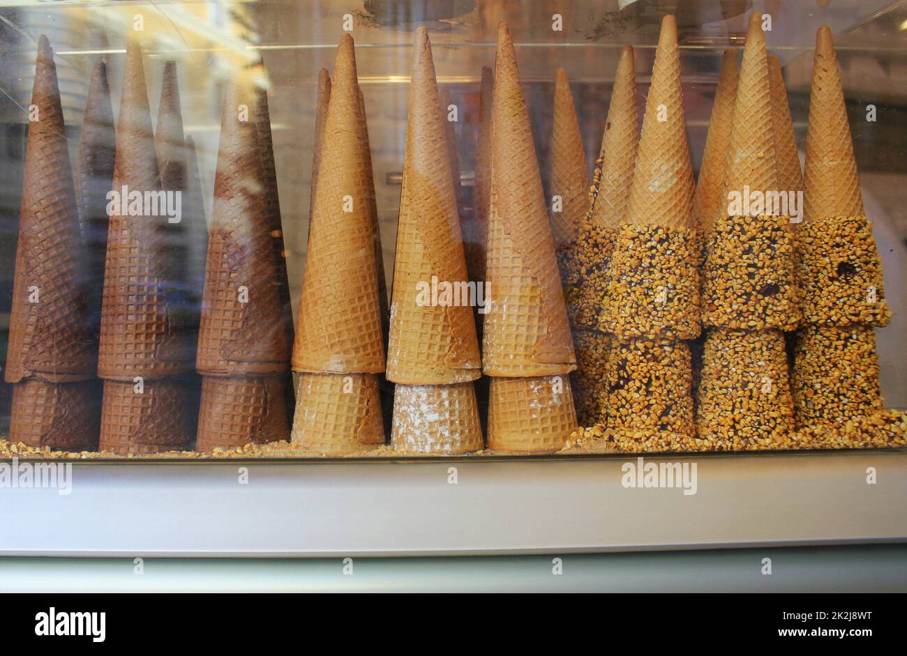 A pile of waffle cones for ice cream ready to be filled with ice cream in a cafe, restaurant. Showcase of a cafe, a pastry shop, a restaurant Stock Photo