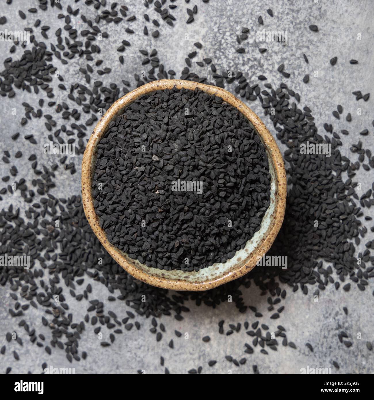 Indian spice Black cumin (nigella sativa or kalonji) seeds in bowl  top view Stock Photo