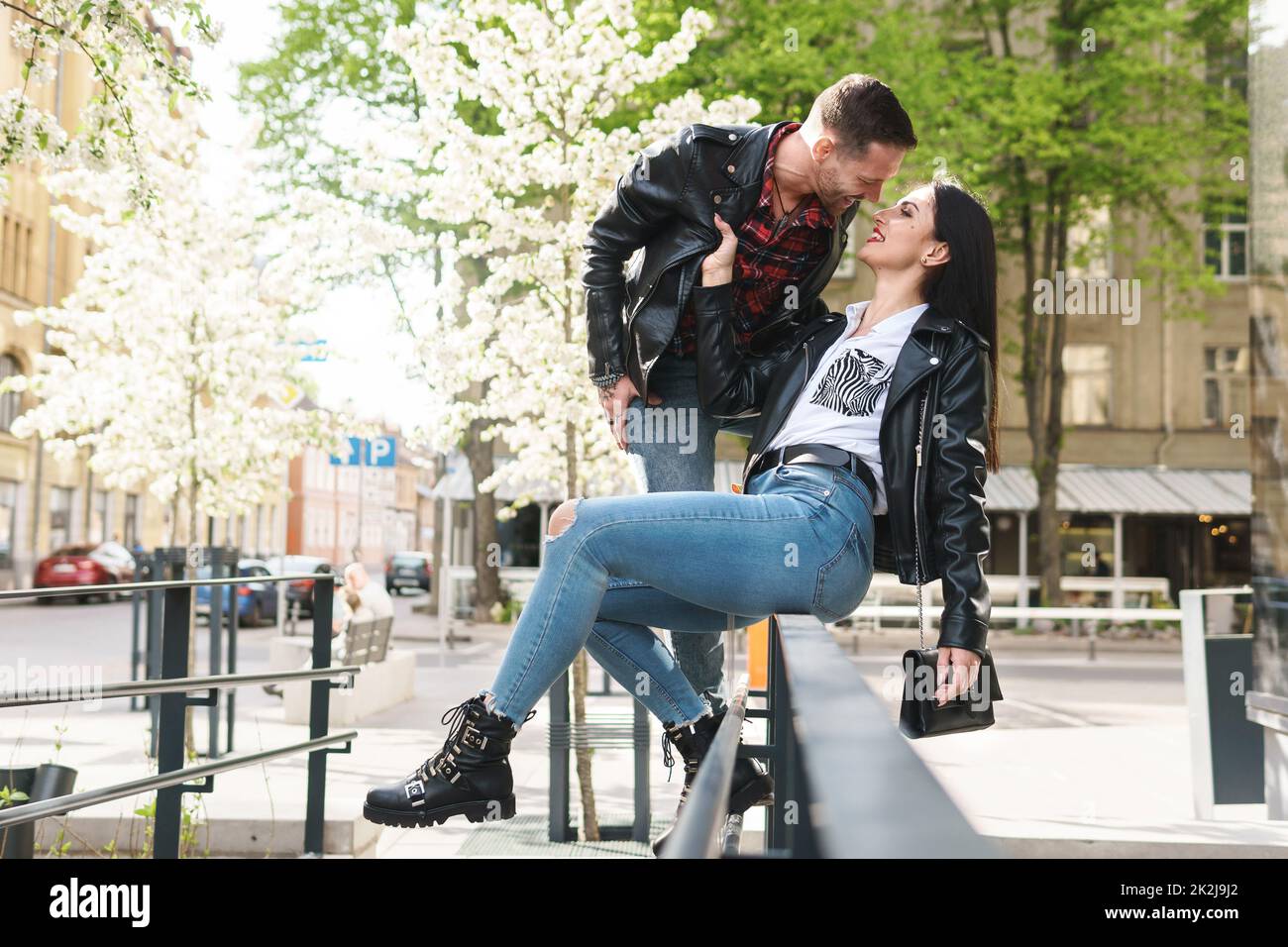 Beautiful couple in love wearing leather jackets during a date on a city street Stock Photo