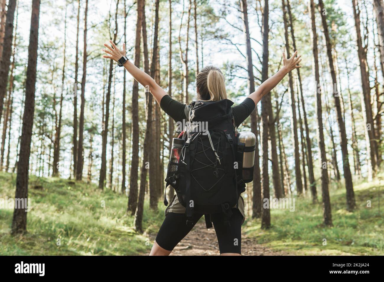 Female hiker with big backpack in green forest Stock Photo - Alamy