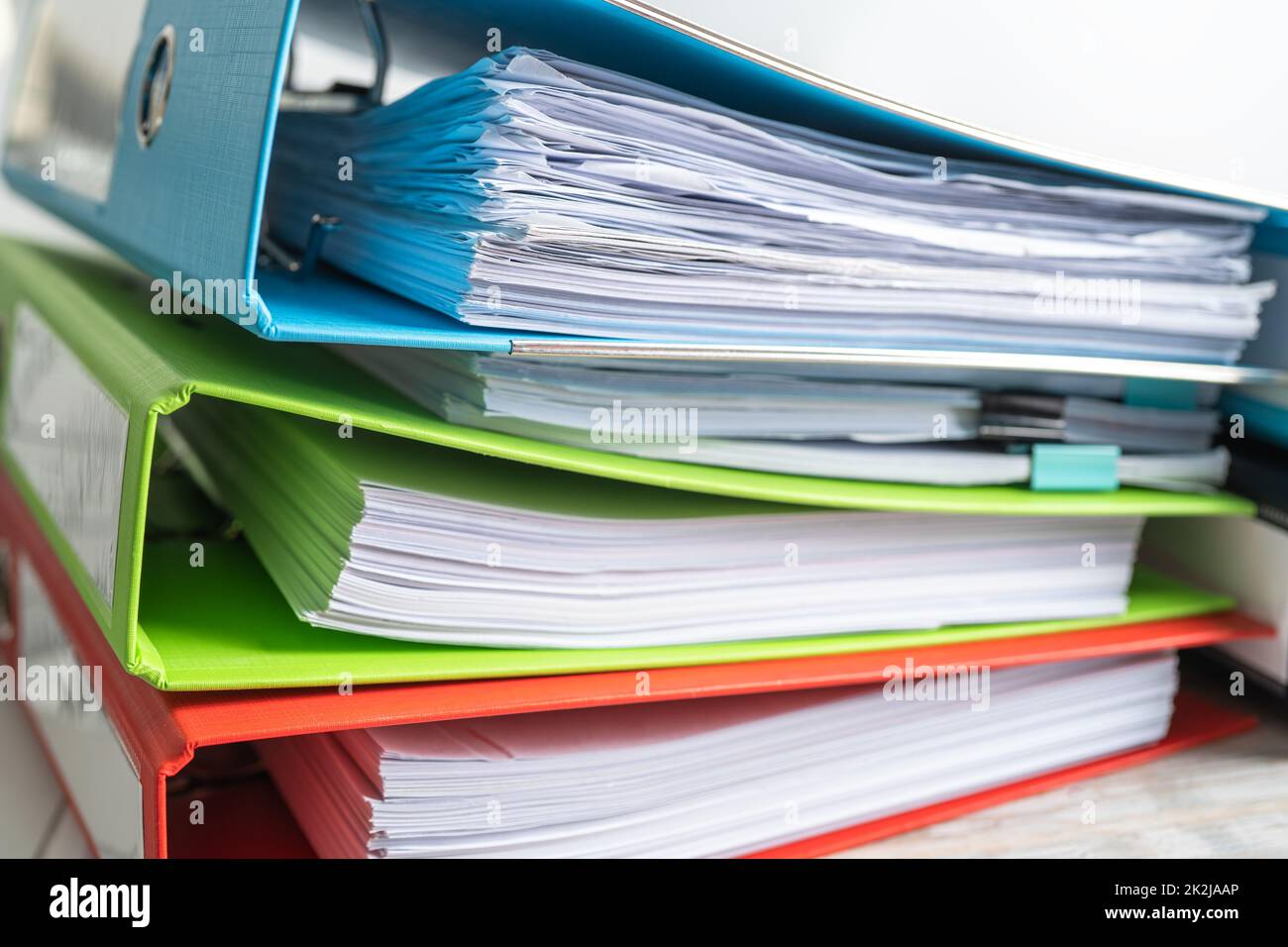File Folder Binder stack of multi color on table in business office. Stock Photo