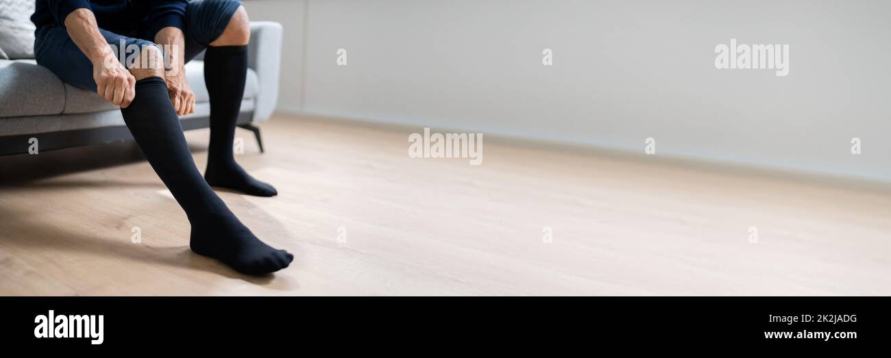 Man Putting On Medical Compression Stockings Stock Photo Alamy