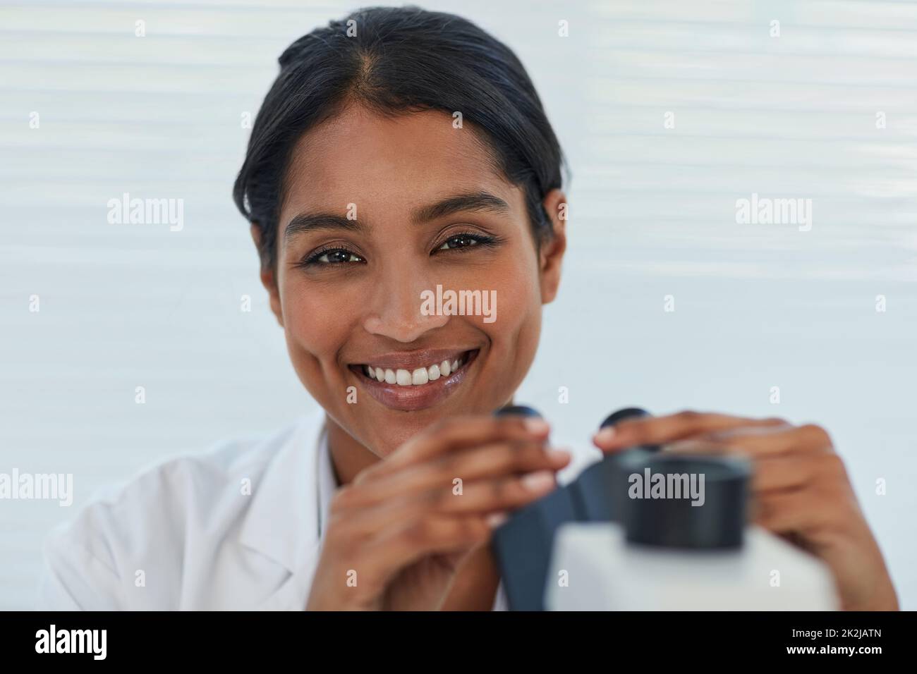 The answers are all in the details. Portrait of a young female scientist working in a lab. Stock Photo