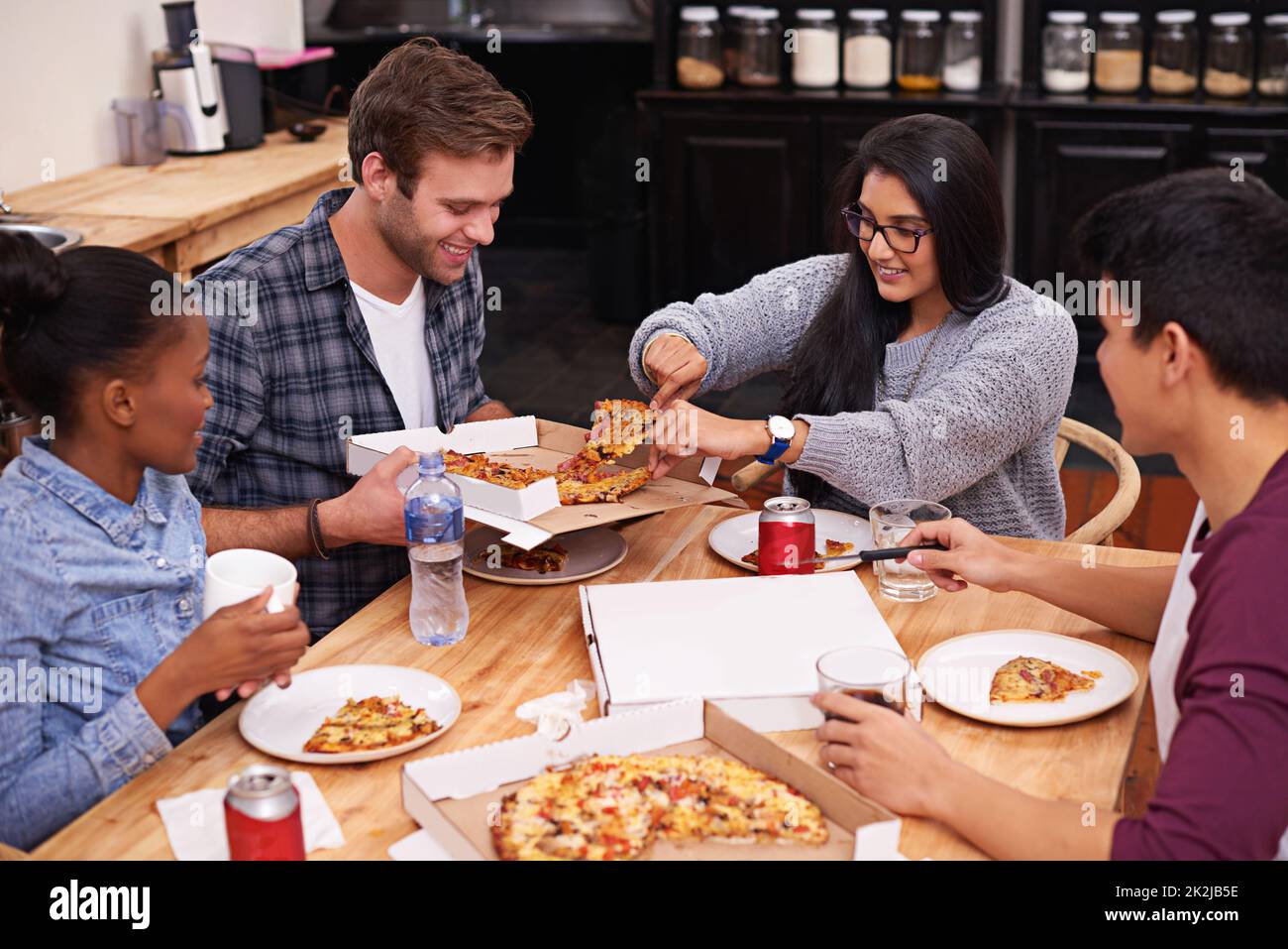 Yumminess awaits. Cropped shot of a group of friends enjoying pizza together. Stock Photo