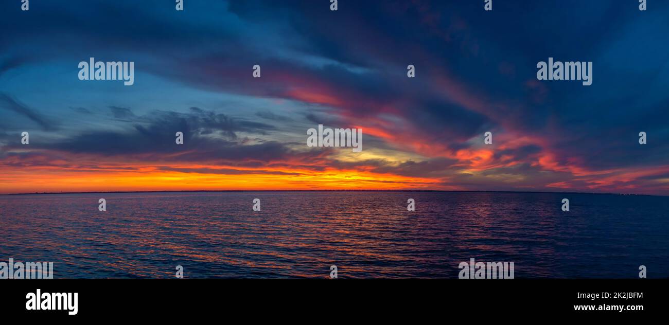 Beautiful sunset over the water surface Stock Photo
