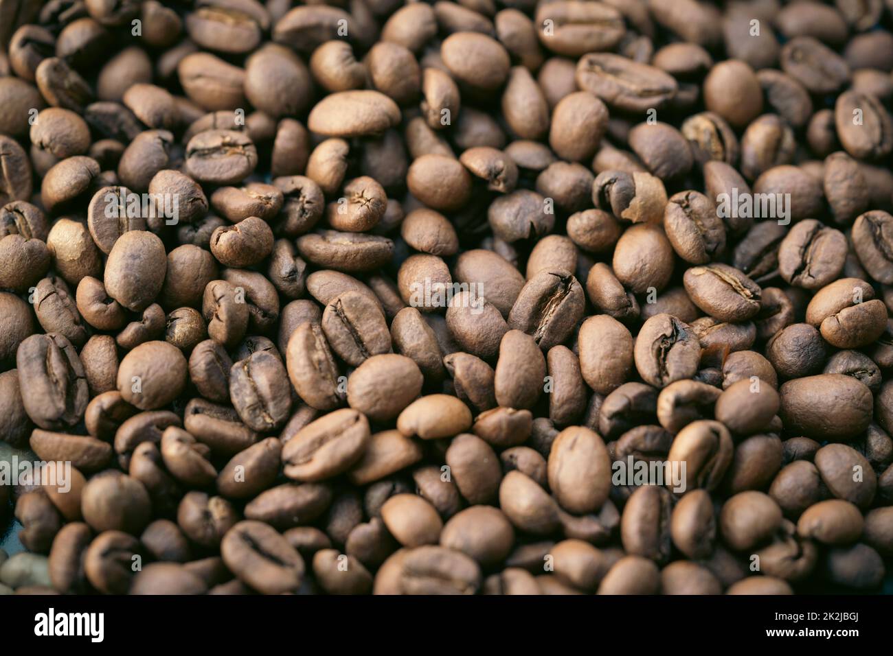 A pile of natural brown roasted coffee beans. Stock Photo