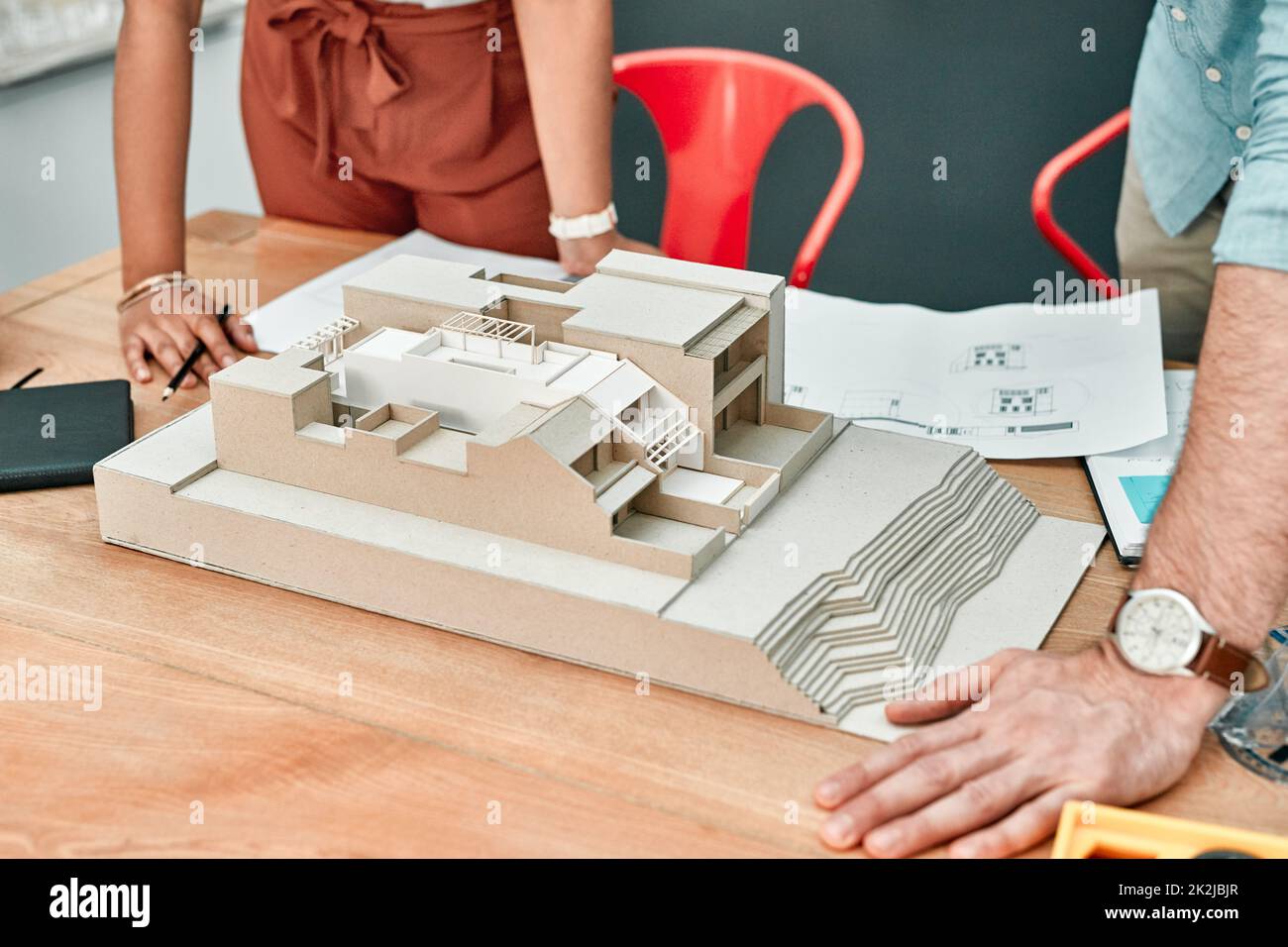 Designing their dreams is part of the job. Closeup shot of two architects working together on a scale model of a building in an office. Stock Photo