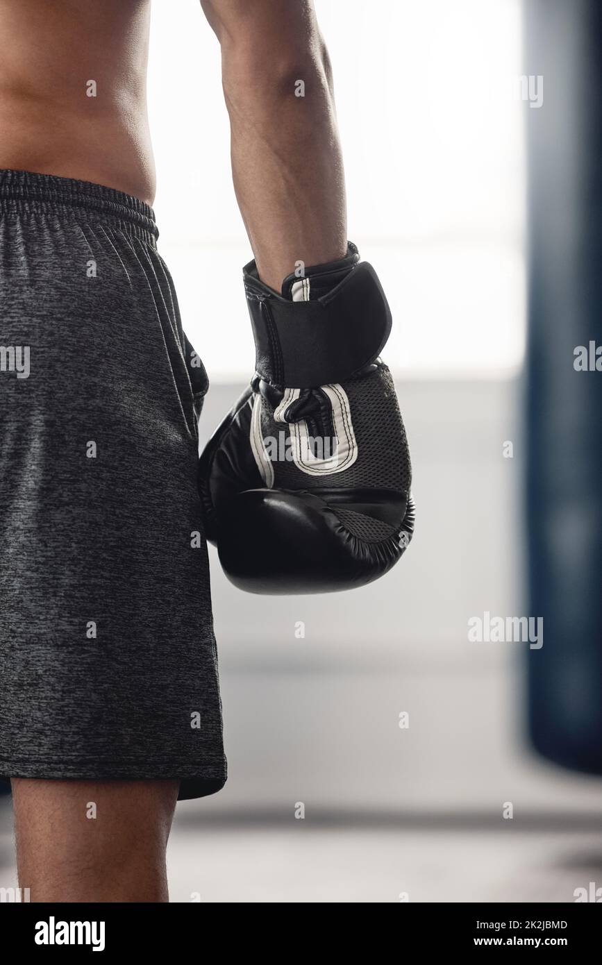 Boxer, fighter glove and hand close up at sports club or gym for training with equipment for fist. Athlete sportswear for protection for mma and Stock Photo