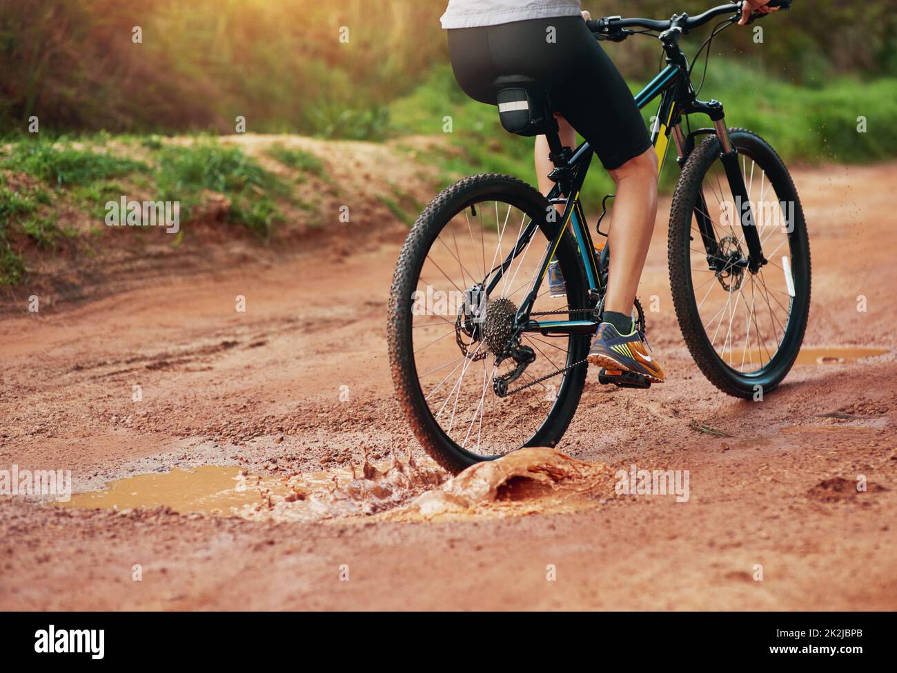What an exhilarating hobby. Shot of a female mountain biker out for an early morning ride. Stock Photo