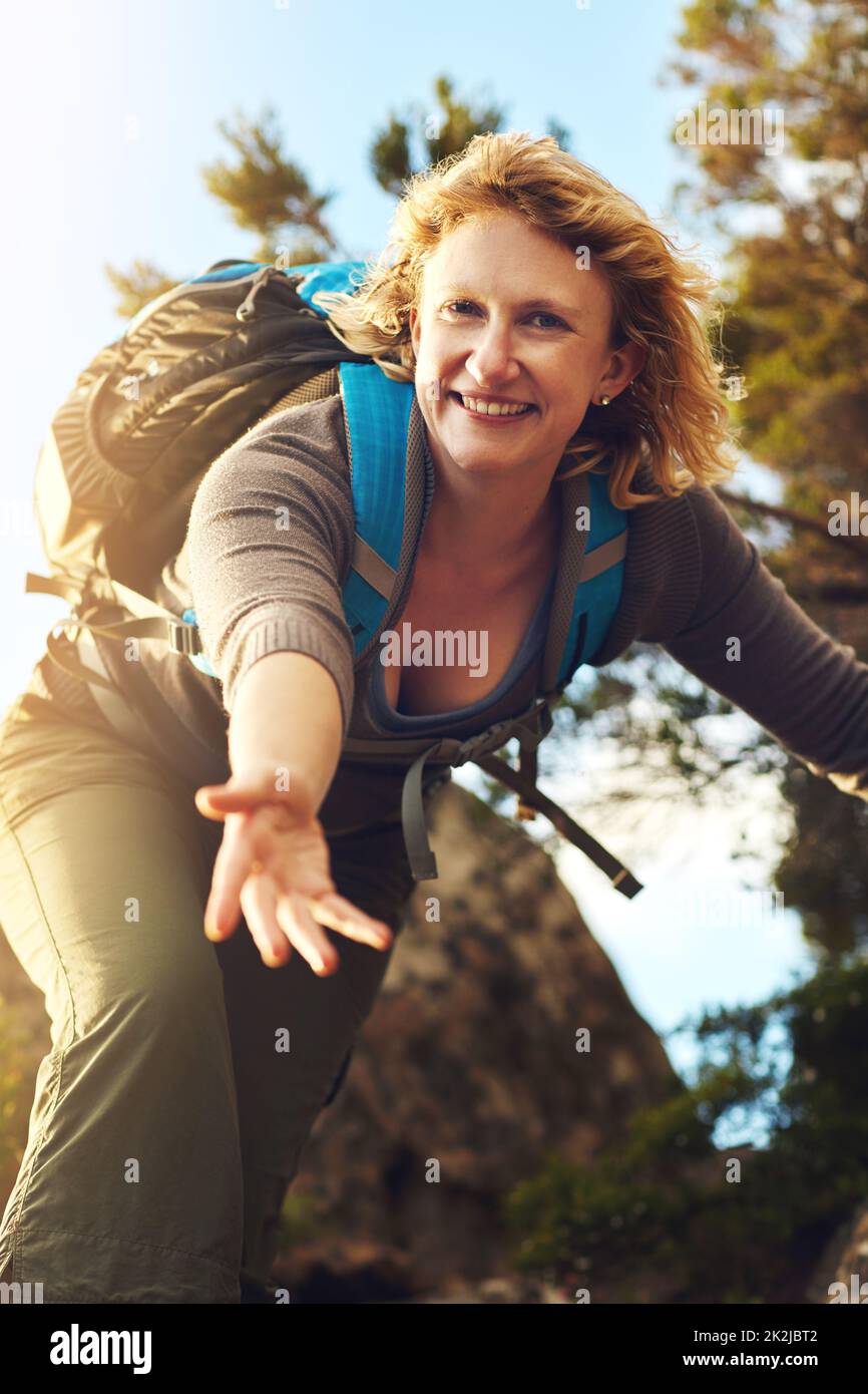 Let your muscles work while resting your brain. Shot of a young woman out mountain climbing. Stock Photo