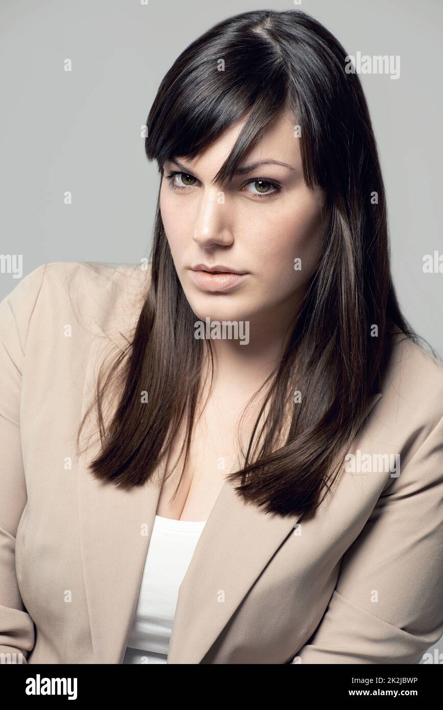 Taking her job seriously. Studio shot of a plussize model posing for the camera Stock Photo Alamy